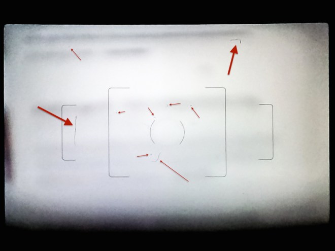 Clearly visible scratches and dust after a botched attempt at cleaning my DSLR's focusing screen.